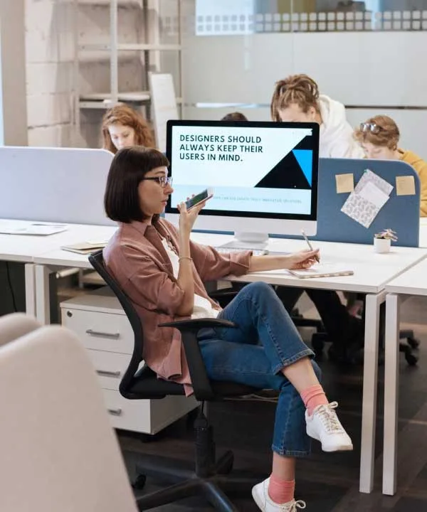 Close-up of a person walking in a modern office setting - Vision section image